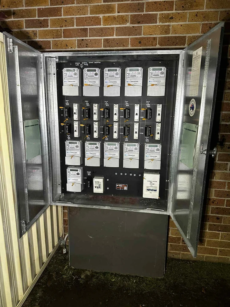 Electric meter and circuit breakers inside an outdoor enclosure