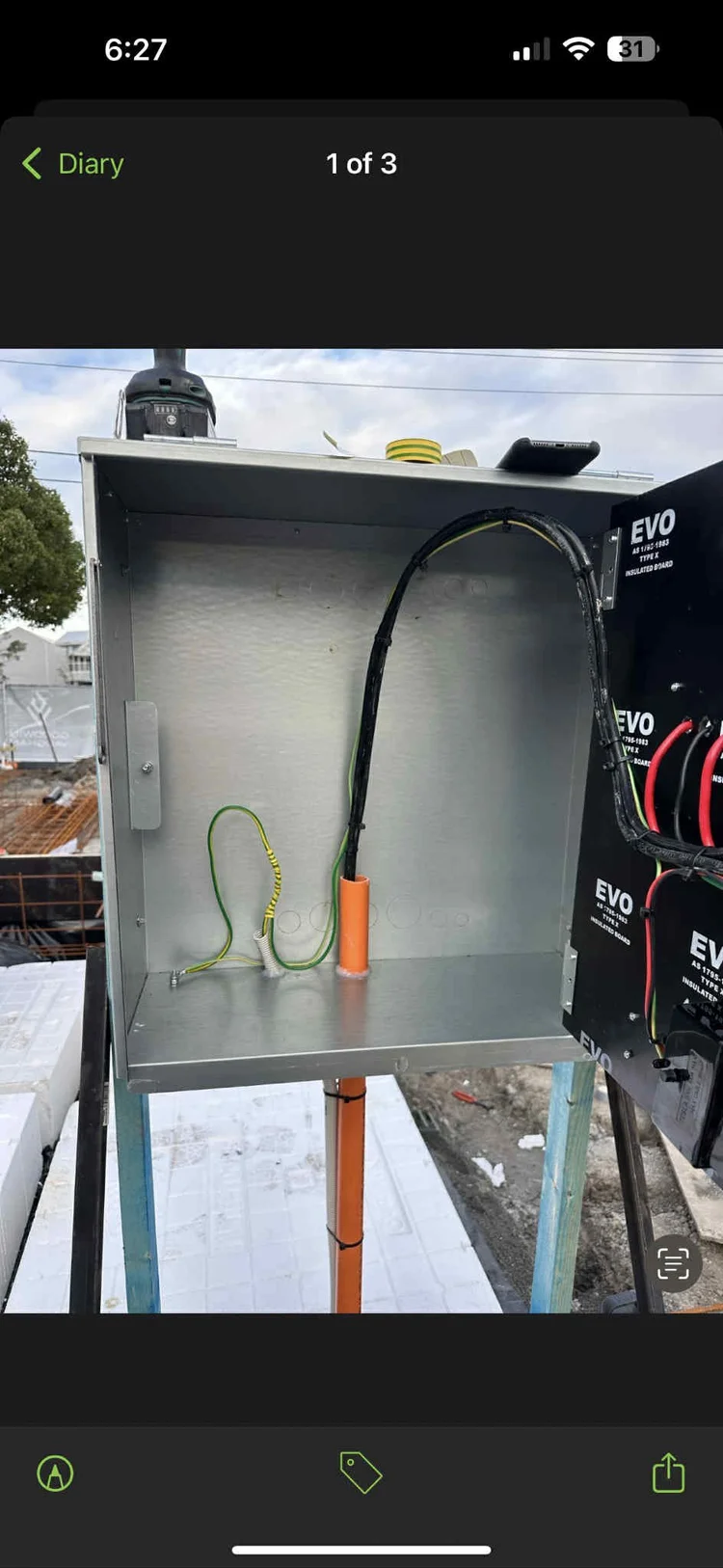 Empty electrical wiring box mounted on a stand at a construction site