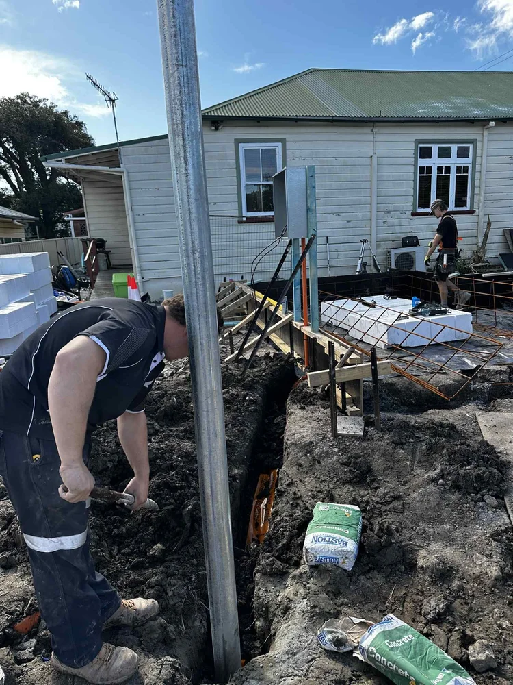 Workers excavating a trench for underground electrical supply